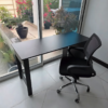 Simple black office desk with ergonomic swivel chair – good condition